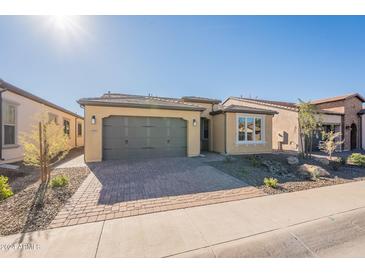 Single-story home with a two-car garage and landscaped front yard at 389 E Bracciano Ave, Queen Creek, AZ 85140