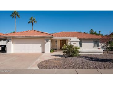 Charming single-story home with white stucco, tile roof, and attached garage at 9625 N 83Rd Way, Scottsdale, AZ 85258