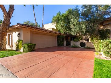 Spanish-style home with a large driveway and lush landscaping at 7500 E Mccormick Pkwy # 29, Scottsdale, AZ 85258