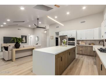 Open concept kitchen features island and living room view at 8544 E Heatherbrae Ave, Scottsdale, AZ 85251