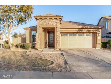 One-story house with stone accents and a two-car garage at 2707 S 103Rd Dr, Tolleson, AZ 85353