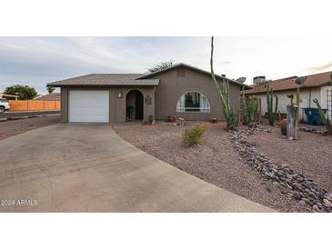 Charming single story home with a landscaped front yard at 723 W 5Th Ave, Apache Junction, AZ 85120