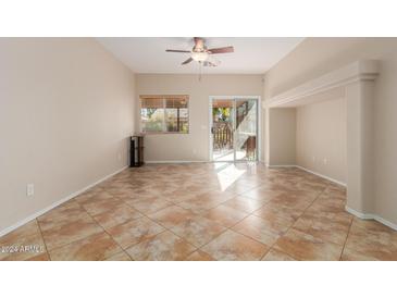 Gathering room with tile floors, ceiling fan and built-in shelving at 805 W Sunset Dr, Coolidge, AZ 85128