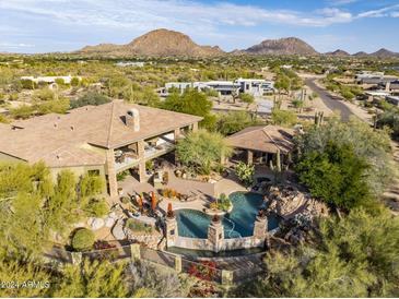 Luxury estate with expansive grounds, pool, and mountain views at 8595 E Bronco Trl, Scottsdale, AZ 85255