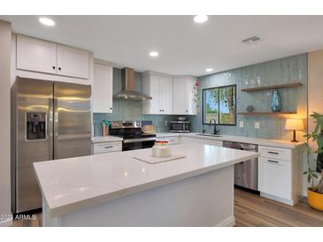 Modern kitchen with stainless steel appliances and white shaker cabinets at 3502 E Janice Way, Phoenix, AZ 85032