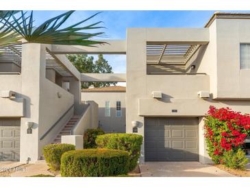 Two-story condo building with attached garage and landscaping at 7710 E Gainey Ranch Rd # 157, Scottsdale, AZ 85258