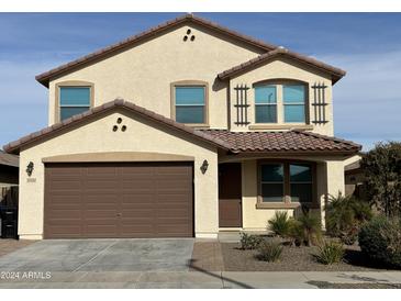 Two-story house with brown garage door and landscaped front yard at 18390 W Via Del Sol --, Surprise, AZ 85387