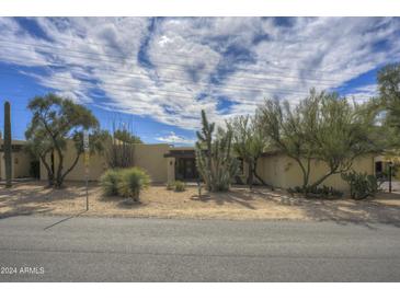 Desert landscape surrounds this mid-century modern home with a spacious front yard at 37801 N Cave Creek Rd # 5, Cave Creek, AZ 85331