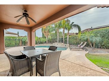 Covered patio with seating area overlooking the pool at 1587 E Luminous Ln, Queen Creek, AZ 85140