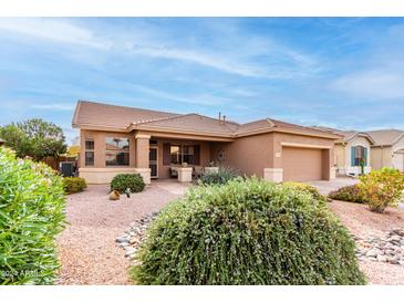 Single-story home with desert landscaping and two-car garage at 17963 W Ryans Way, Surprise, AZ 85374