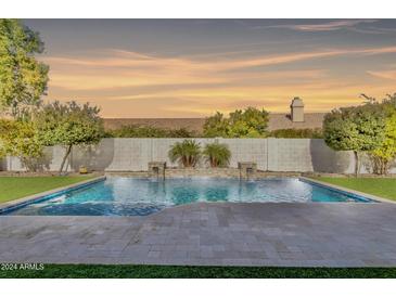 Inviting backyard pool with a stone patio and water features at 4948 E Dale Ln, Cave Creek, AZ 85331