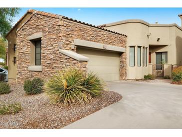 Attractive stucco and stone exterior with 2-car garage and landscaping at 7445 E Eagle Crest Dr # 1093, Mesa, AZ 85207