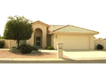 One-story house with tan exterior, tile roof, and two-car garage at 26002 S Boxwood Dr, Sun Lakes, AZ 85248