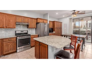 Spacious kitchen with granite countertops, wood cabinets, and stainless steel appliances at 32405 N 23Rd Ave, Phoenix, AZ 85085