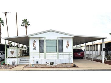 Single-wide manufactured home with covered carport and small front yard at 205 S Higley Rd # 218, Mesa, AZ 85206