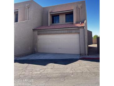 Tan two-story stucco home with attached garage and Spanish tile roof at 7434 N 44Th Dr, Glendale, AZ 85301