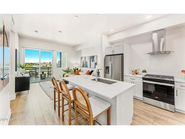 Modern kitchen with white cabinets, stainless steel appliances, and an island at 3131 N Central Ave # 6020, Phoenix, AZ 85012