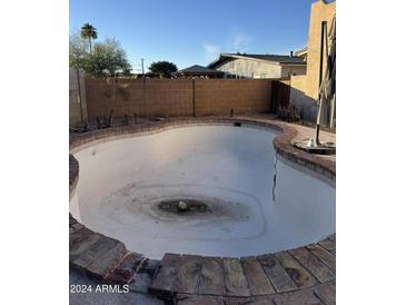 Inviting kidney-shaped pool, ready for your personal touch at 4731 E Monte Vista Rd, Phoenix, AZ 85008