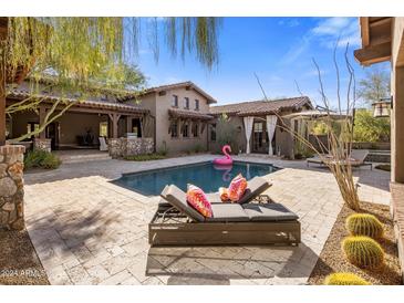 Luxury backyard oasis with a sparkling pool and comfortable lounge area at 7262 E Lower Wash Pass, Scottsdale, AZ 85266