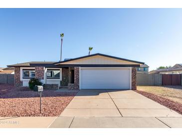 Single story home with a two-car garage and well-maintained landscaping at 17621 N 18Th Dr, Phoenix, AZ 85023