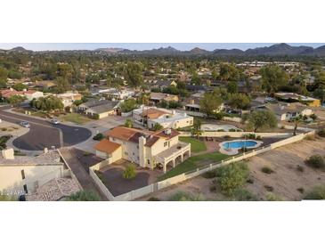 Aerial view of house, pool, and surrounding neighborhood at 219 W Kathleen Rd, Phoenix, AZ 85023