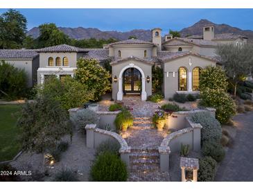 Stunning luxury home with a brick pathway, arched entryway and mountain views at 19149 N 99Th St, Scottsdale, AZ 85255