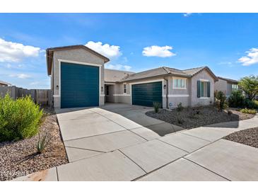 House exterior, two-car garage, and desert landscaping at 2860 N Riverdale Ln, Casa Grande, AZ 85122