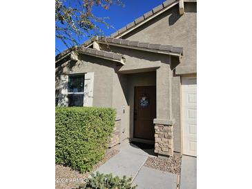 Well-maintained house with attractive landscaping and a two-car garage at 532 W Tenia Trl, San Tan Valley, AZ 85140