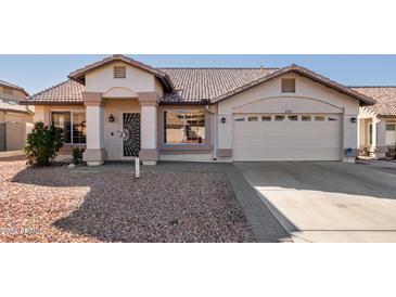 Charming single-story home with a two-car garage and well-maintained landscaping at 10749 W Tonopah Dr, Sun City, AZ 85373