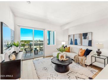 Bright living room with city view, featuring a comfy sofa and stylish coffee table at 3131 N Central Ave # 6017, Phoenix, AZ 85012