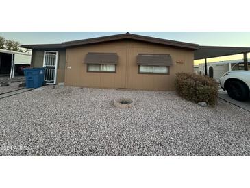 Tan single-wide manufactured home with gravel landscaping at 6723 W Fillmore St # 301, Phoenix, AZ 85043