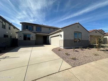 Two story house with attached garage and desert landscaping at 27018 N 168Th Ln, Surprise, AZ 85387