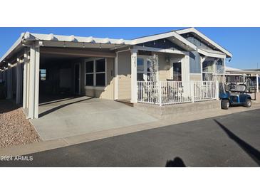 Single-wide manufactured home with carport and covered patio at 650 N Hawes Rd # 4101, Mesa, AZ 85207