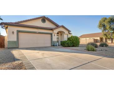 Single-story home with a two-car garage and well-maintained landscaping at 28320 N Tourmaline Dr, San Tan Valley, AZ 85143