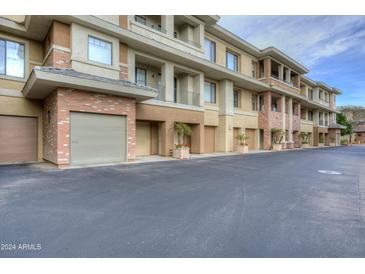 Modern condo building with attached garages and landscaped grounds at 2989 N 44Th St # 1034, Phoenix, AZ 85018