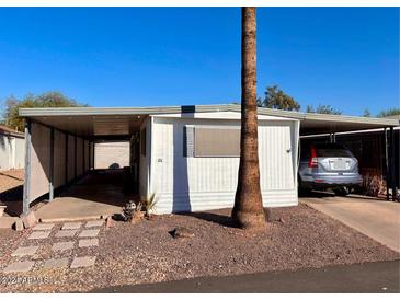 Mobile home exterior with carport and landscaping at 500 N 67Th Ave # 44, Phoenix, AZ 85043