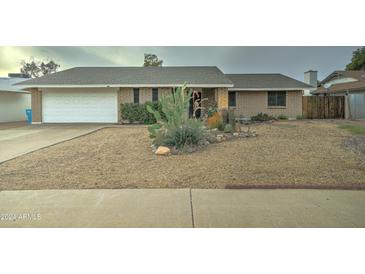 Brick ranch house with desert landscaping and a two-car garage at 17628 N 39Th Ave, Glendale, AZ 85308