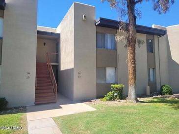 Exterior view of a two-story building with stairs and landscaping at 4201 E Camelback Rd # 14, Phoenix, AZ 85018