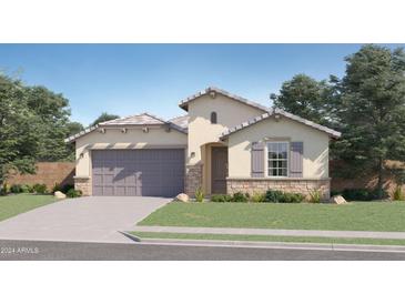 One-story home with stone accents, landscaped lawn, and attached garage at 16673 W Charlotte Dr, Surprise, AZ 85387