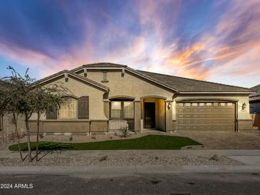 Attractive single-story home with a two-car garage and landscaped front yard at 16068 W Questa Dr, Surprise, AZ 85387