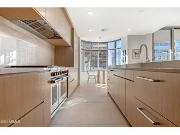 Sleek kitchen featuring stainless steel appliances and light wood cabinetry at 2402 E Esplanade Ln # 601, Phoenix, AZ 85016