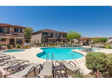 Community pool with lounge chairs and spa at 42424 N Gavilan Peak Pkwy # 42206, Anthem, AZ 85086