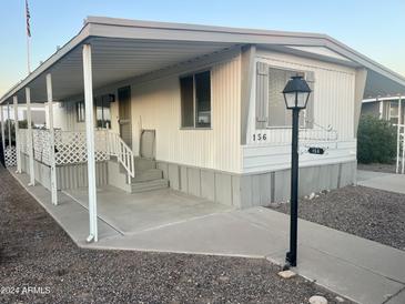 Mobile home exterior with covered porch and landscaped yard at 11411 N 91St Ave # 156, Peoria, AZ 85345