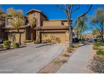 Tan two-story home with attached garage and landscaped front yard at 21320 N 56Th St # 2175, Phoenix, AZ 85054