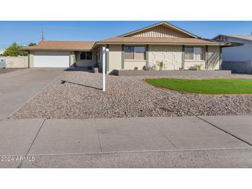 Single story home with a well-manicured lawn and driveway at 3548 W Frier Dr, Phoenix, AZ 85051