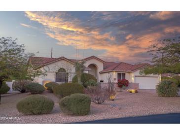 Single-story home with desert landscaping and a tile roof at 730 E Mesquite St, Phoenix, AZ 85086