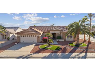 Single story home with attractive landscaping and a two-car garage at 14727 W Via Manana --, Sun City West, AZ 85375