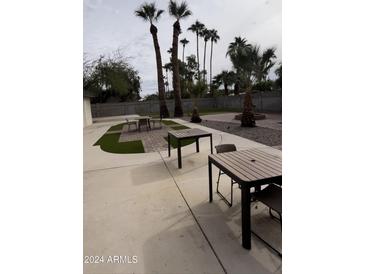 Spacious backyard with patio furniture and artificial turf at 5529 E Bloomfield Rd, Scottsdale, AZ 85254