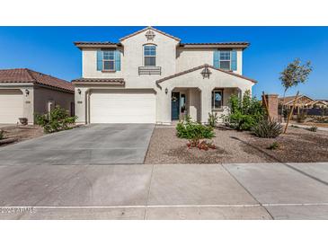 Two-story house with light-colored exterior, a two-car garage, and landscaping at 10254 W Piccadilly Rd, Avondale, AZ 85392