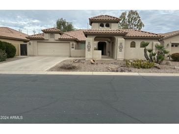 Spanish style home with a two-car garage and desert landscaping at 8846 E Copper Dr, Sun Lakes, AZ 85248